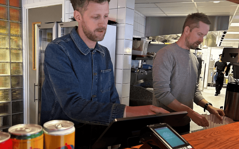 Working the till behind the bar